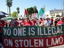 People march with a banner that reads
