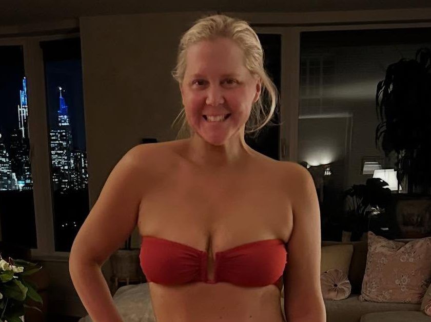 Amy Schumer modelling a red strapless bikini.