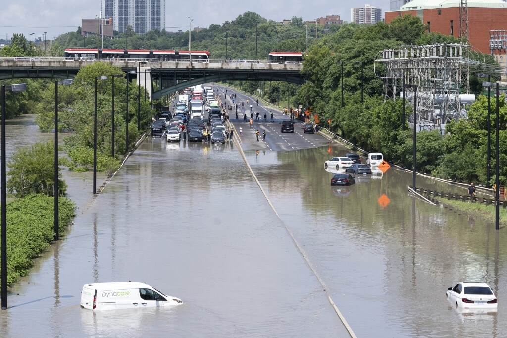  Cars are partly submerged in flood waters in the Don Valley following heavy rain in Toronto on July 16, 2024. The tendency of the valley to flood has some worried about large basements in Hoggs Hollow, further upstream.