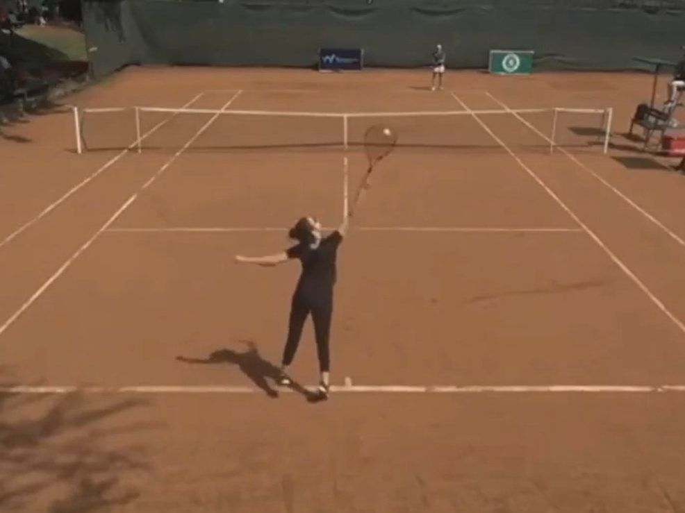 Hajar Abdelkader, foreground, attempts to serve against Lorena Schaedel.