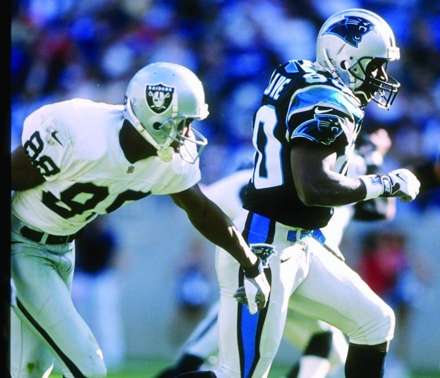  Wide receiver Dwight Stone of the Carolina Panthers is chased by defensive lineman Kevin Johnson, left, of the Oakland Raiders during a game at Ericsson Stadium in Charlotte, N.C., on Nov. 2, 1997. Johnson was found dead on Jan. 21 inside a homeless encampment in the Willowbrook area of south Los Angeles. Police now believe his murder might be linked to three other killings involving homeless people in L.A.