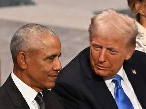 Donald Trump (right) speaks with Barack Obama.