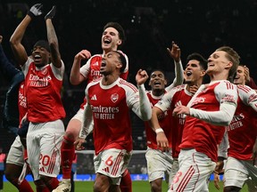 Arsenal celebrate their victory at the end of the English Premier League football match against Tottenham Hotspur.