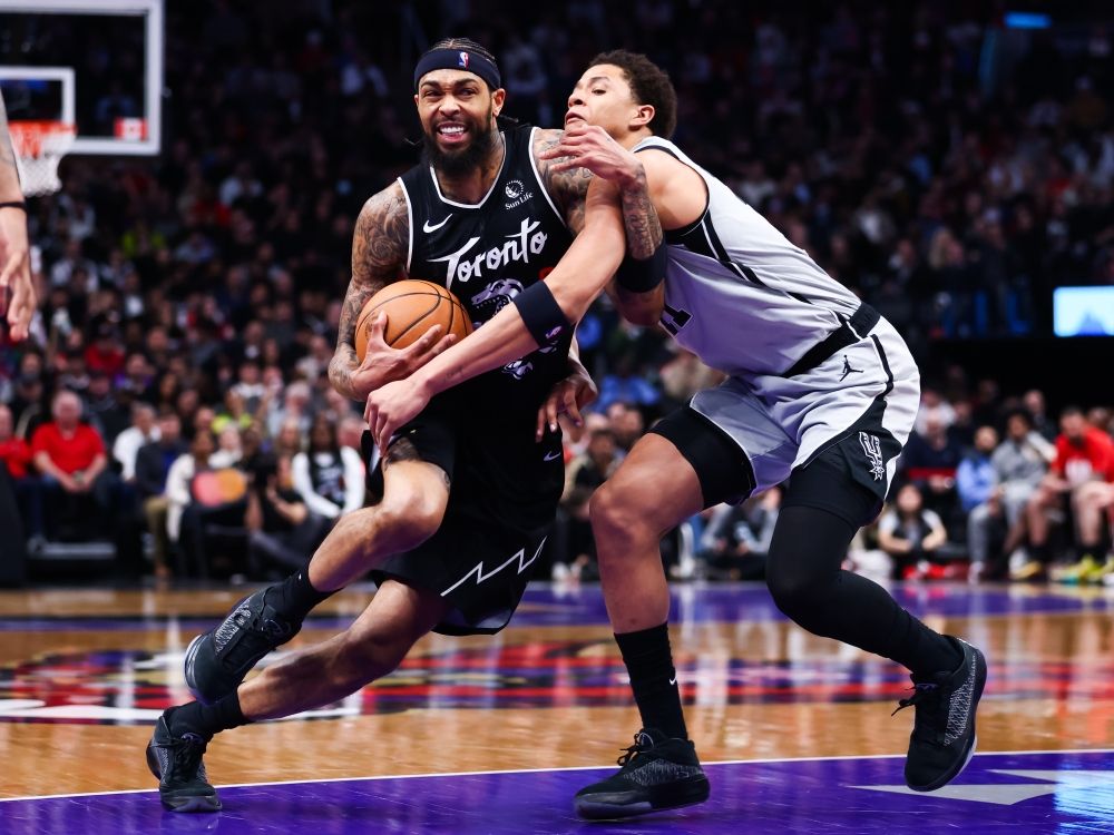 Brandon Ingram of the Toronto Raptors drives to the net against Carter Bryant of the San Antonio Spurs.