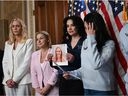 Family and supporters hold a photo of Virginia Giuffre, an accuser of Jeffrey Epstein, during a news conference to introduce