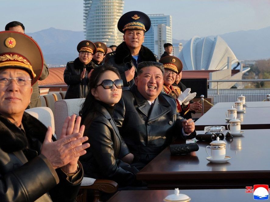 This picture taken on November 28, 2025 and released by North Korea's official Korean Central News Agency (KCNA) on November 30, 2025 shows North Korean leader Kim Jong Un (3rd L) and his daughter Ju Ae (2nd L) watching a demonstration flight commemorating the 80th anniversary of the founding of the Korean People's Army Air Force at Kalma Airfield in Wonsan, Gangwon Province.  