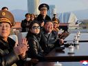 This picture taken on November 28, 2025 and released by North Korea's official Korean Central News Agency (KCNA) on November 30, 2025 shows North Korean leader Kim Jong Un (3rd L) and his daughter Ju Ae (2nd L) watching a demonstration flight commemorating the 80th anniversary of the founding of the Korean People's Army Air Force at Kalma Airfield in Wonsan, Gangwon Province.