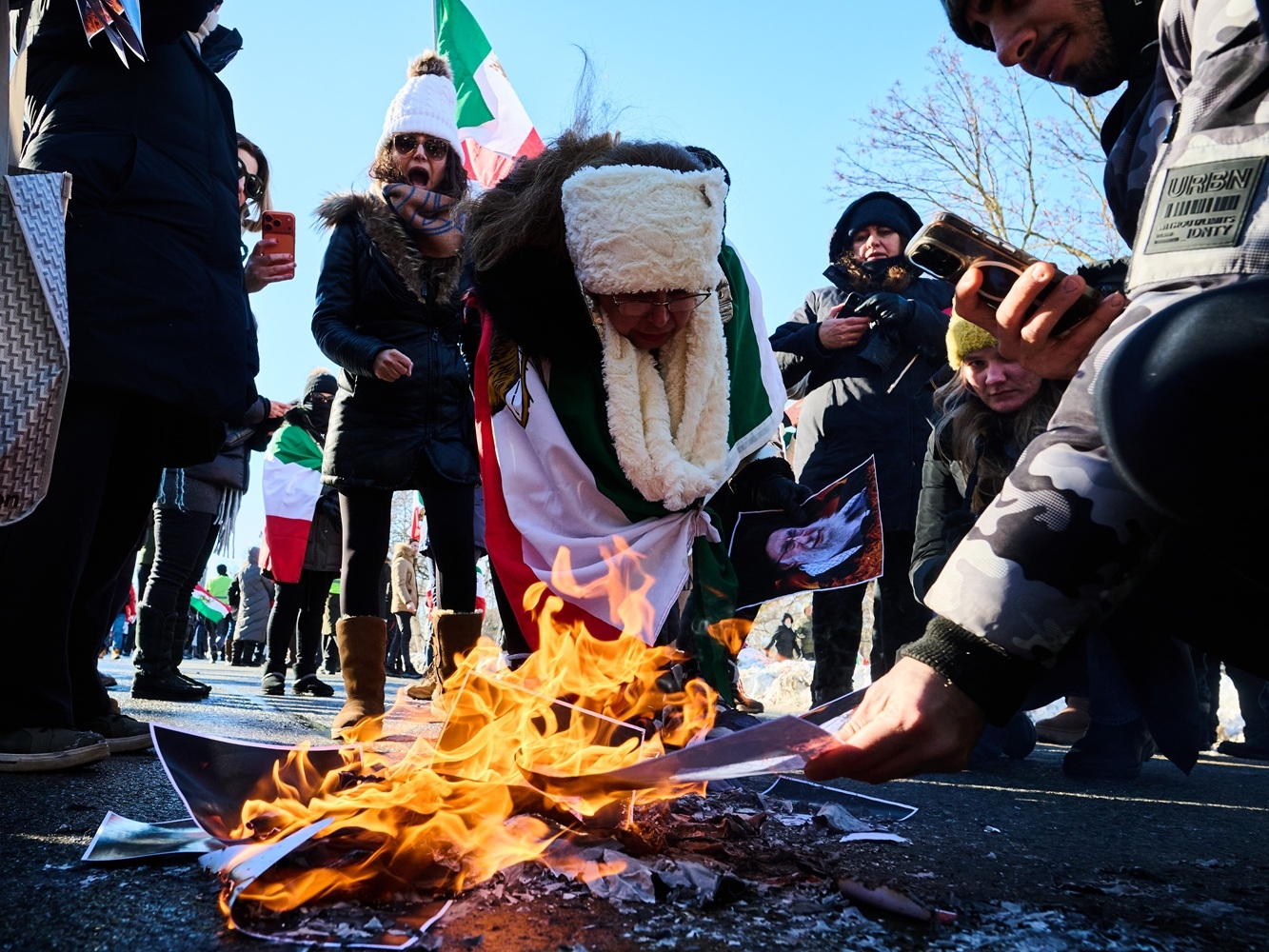  Protesters burn pictures of Iranian Supreme Leader Ayatollah Ali Khamenei as they march in support of regime change in Iran during a protest in Toronto, on Sunday, Feb. 1, 2026.