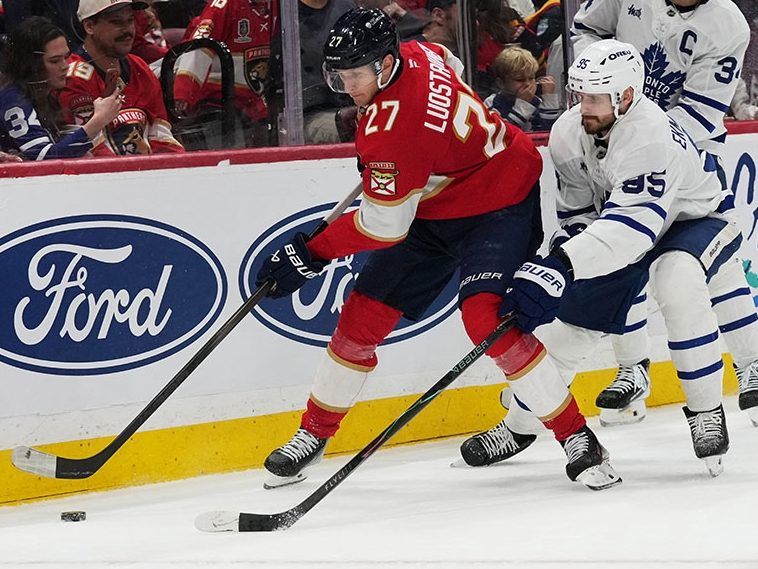 Florida Panthers center Eetu Luostarinen tries to shield the puck against Maple Leafs defenceman Oliver Ekman-Larsson during the second period on  Thursday, Feb. 26, 2026, in Sunrise, Fla.