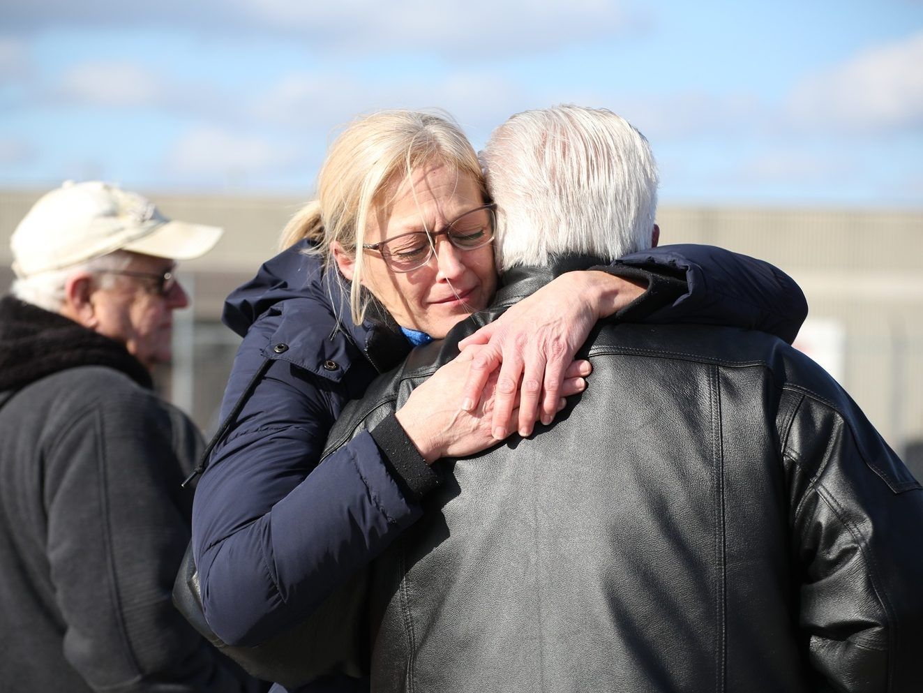 Kathy Delmore, a bottling operator with 25 years at the Diageo Crown Royal whisky plant in Amherstburg, Ont., hugs her father outside of the gates after being told mid-shift that Wednesday, Feb. 25, 2026, would be workers' last day at the facility. 
