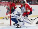 Toronto Maple Leafs goaltender Joseph Woll (60) defends a shot by Florida Panthers left wing A.J. Greer (10) during the second period of an NHL hockey game on Thursday, in Sunrise, Fla.