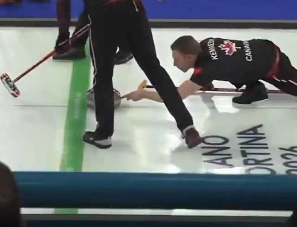 A still from video shows Canadian curler Marc Kennedy releasing the stone during an Olympic match against Team Sweden on Friday, Feb. 13, 2026.