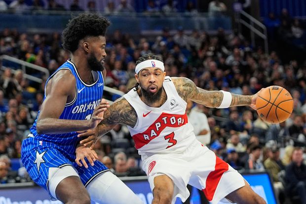 Toronto Raptors forward Brandon Ingram (3) makes a move against Orlando Magic forward Jonathan Isaac, left, during the second half of an NBA basketball game, Friday, Jan. 30, 2026, in Orlando, Fla. (AP Photo/John Raoux)