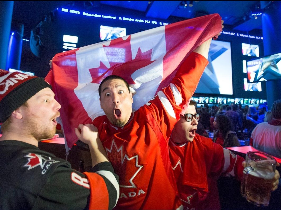 Hockey fans celebrate as Team Canada beats Team U.S.A. in semifinal Olympic hockey action on the big screen at the Real Sports bar in Toronto, Ont. on Friday, Feb. 21, 2014.