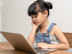 A girl uses a laptop.