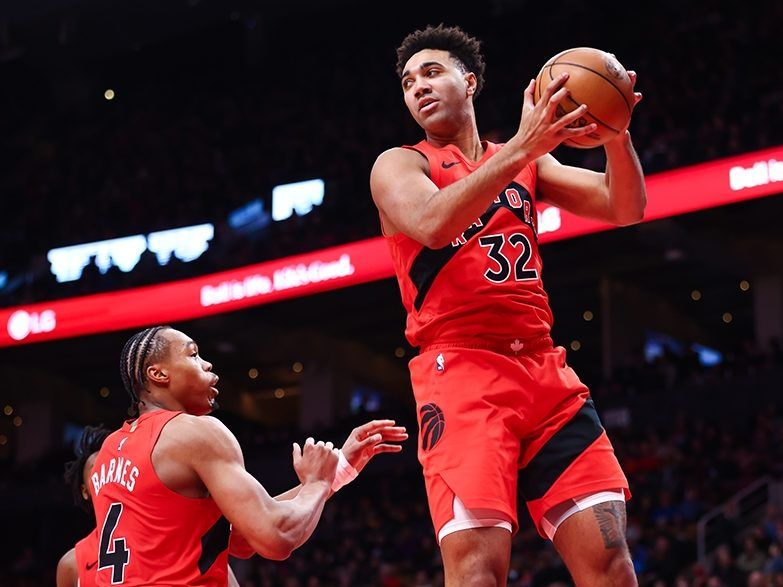 Raptors newcomer Trayce Jackson-Davis grabs a rebound against the Indiana Pacers at Scotiabank Arena on February 8, 2026 while teammate Scottie Barnes looks on.