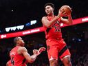 Raptors newcomer Trayce Jackson-Davis grabs a rebound against the Indiana Pacers at Scotiabank Arena on February 8, 2026 while teammate Scottie Barnes looks on.