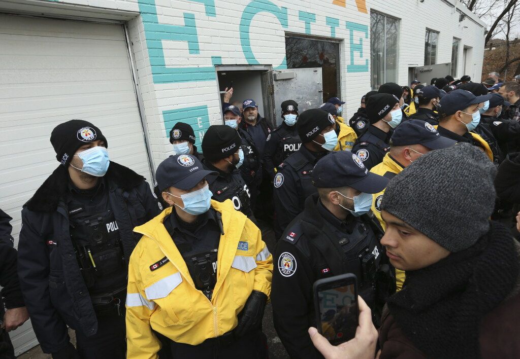 Toronto Police officers block the side door outside Adamson Barbecue on Queen Elizabeth Blvd. on Thursday November 26, 2020.