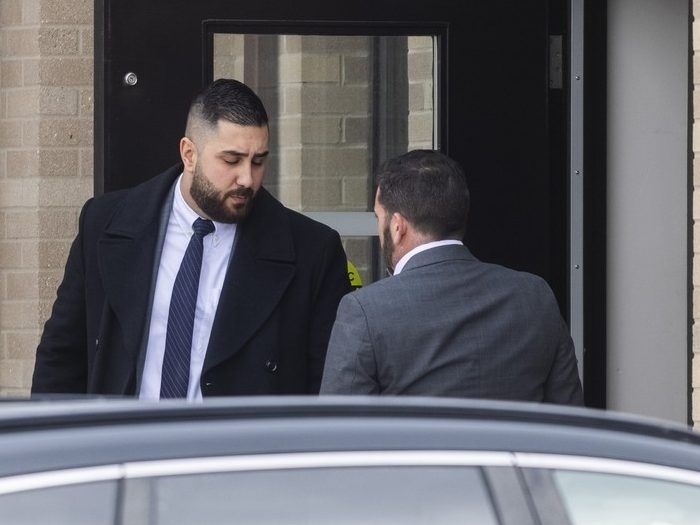 Toronto Police Service officer Const. Elias Mouawad (left) leaves 22 Division in Etobicoke on Thursday Feb. 5, 2026. Const. Mouawadis one of seven TPS officers and one now-retired cop arrested as part of a bombshell, wide-ranging probe into police corruption. 