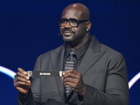 Former NBA player Shaquille O'Neal holds up Iran after drawing from a pot during the draw for the 2026 World Cup.