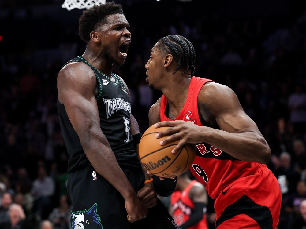 Minnesota Timberwolves guard Anthony Edwards (5) celebrates his dunk in front of Toronto Raptors forward RJ Barrett.