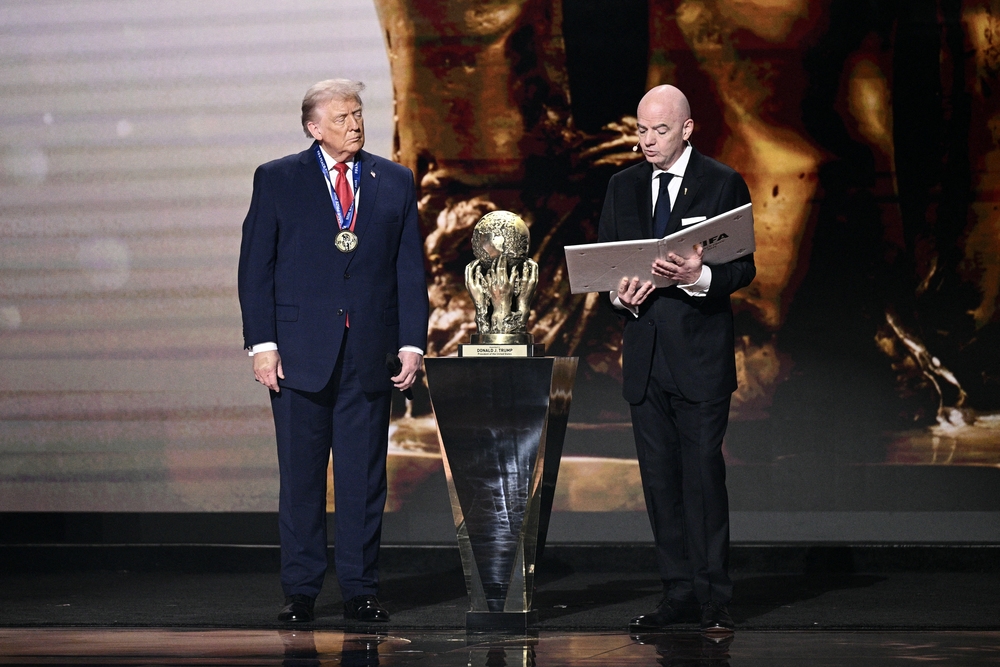 U.S. President Donald Trump looks on as he receives the FIFA Peace Prize from FIFA President Gianni Infantino during the draw for the 2026 FIFA World Cup.