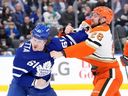 Michael Pezzetta of the Toronto Maple Leafs fights with Jeffrey Viel of the Anaheim Ducks during the first period of an NHL game in Toronto on March 12, 2026.