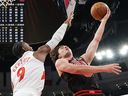 Toronto Raptors guard RJ Barrett (left) defends against Chicago Bulls guard Josh Giddey during the first half of an NBA game in Chicago on March 18, 2026.