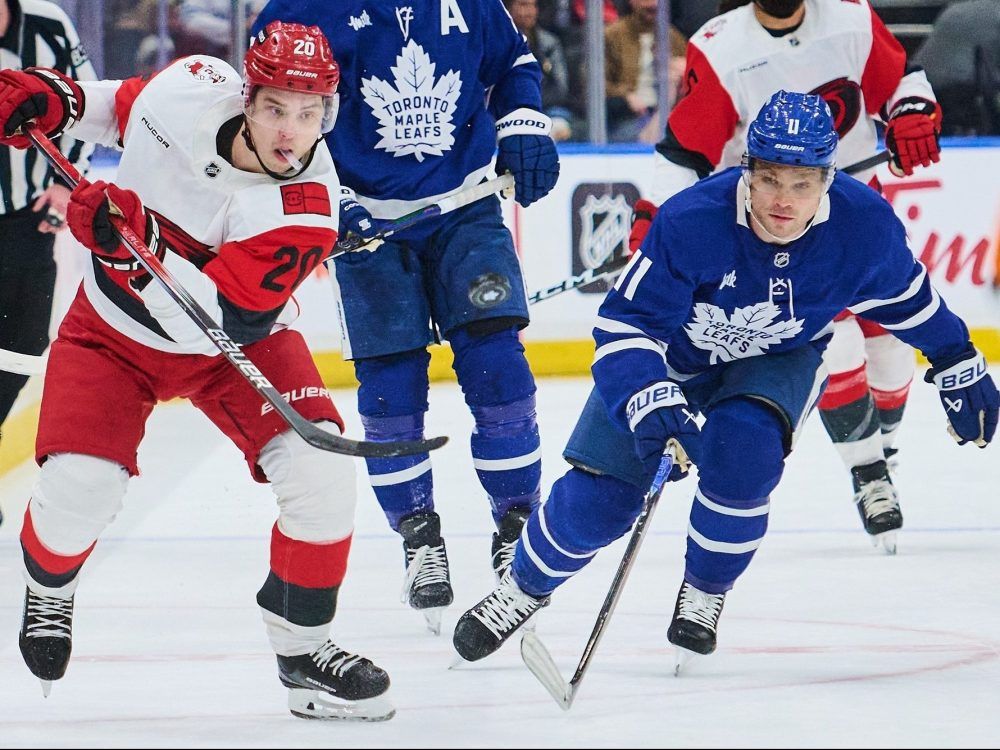 Carolina Hurricanes centre Sebastian Aho (left) and Maple Leafs forward Max Domi battle for the puck in Toronto on March 20, 2026.