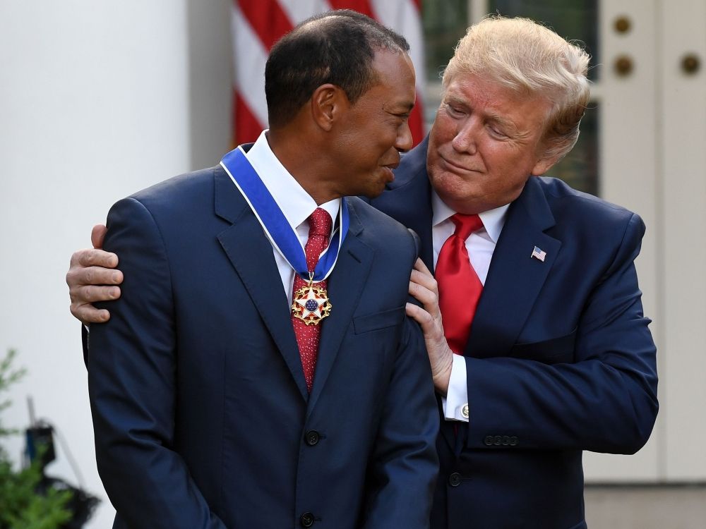 US President Donald Trump presents golfer Tiger Woods with the Presidential Medal of Freedom during a ceremony in 2019.