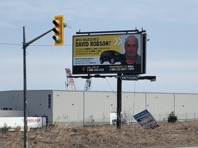 A billboard outside of Orangeville, Ont., with a picture of David Robson, who was reported missing from Melancthon Township on March 21, 2024.