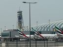 Emirates airline planes are parked on the tarmac at Dubai International Airport in Dubai on March 2, 2026.
