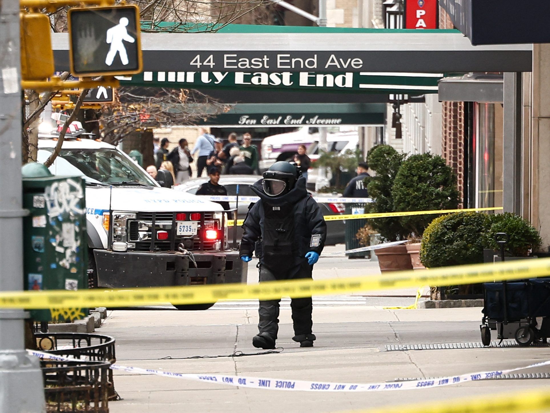 A NYPD officer wearing an Explosive Ordonance Disposal suit investigates a scene a few blocks from Gracie Mansion.