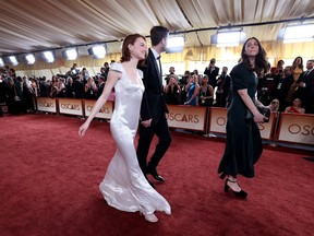Actress Emma Stone and her guest attend the 98th annual Academy Awards.