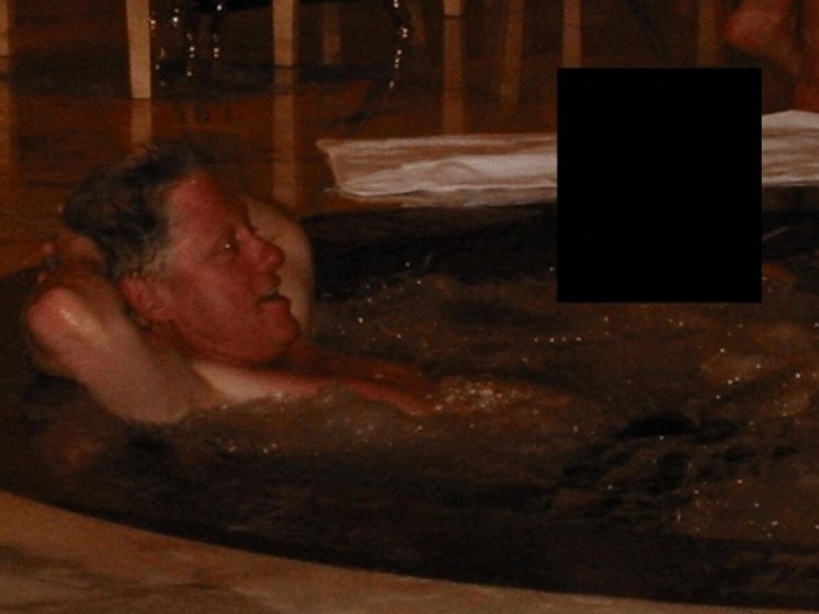  Former U.S. president Bill Clinton in a hot tub with an unidentified person.