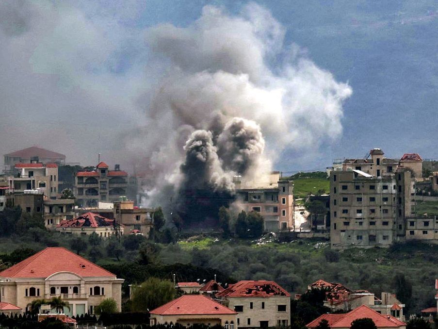 Smoke plumes rise following Israeli bombardment on the village of Khiam in southern Lebanon near the border with Israel, as seen from nearby Marjayoun, on March 16, 2026.