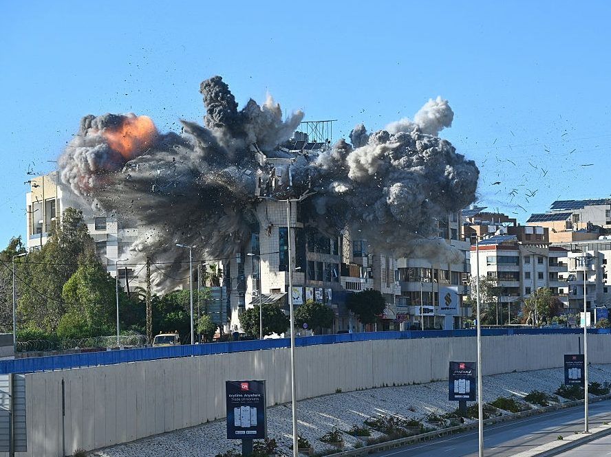 A ball of fire rises from the site of an Israeli strike that targeted a building adjacent to the highway that leads to Beirut's international airport on March 31, 2026.