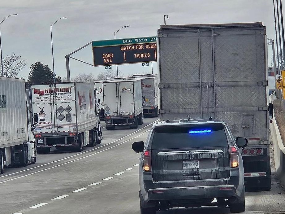 An image from OPP of a transport truck pulled over with its driver being charged for being on a Microsoft Teams meeting.