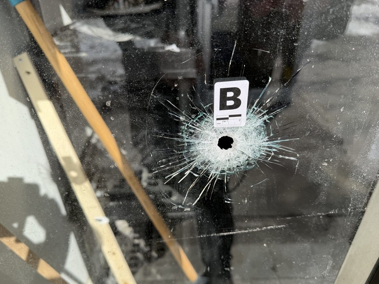  An evidence marker is seen above a bullet hole in a window at Saliwan Boxing Club in Richmond Hill, Ont., on Sunday, March 1, 2026.