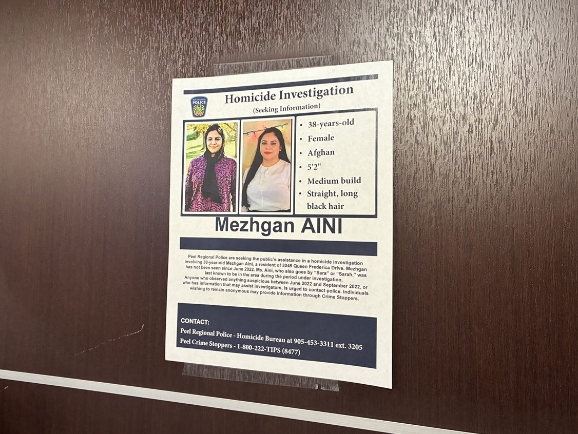  A Peel Regional Police poster attached to the wall in an apartment building where Mezhgan Aini lived in Mississauga, Ont.