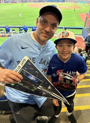 Ivan Dzaia and his 10-year-old son Antonio attend the Blue Jays season opener at Rogers Centre, Friday, March 27, 2026.