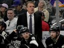 Los Angeles Kings head coach Jim Hiller stands behind the bench during an NHL hockey game against the Tampa Bay Lightning, Jan. 1, 2026, in Los Angeles.