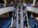 People use the escalator at the Metro Toronto Convention Centre Monday.