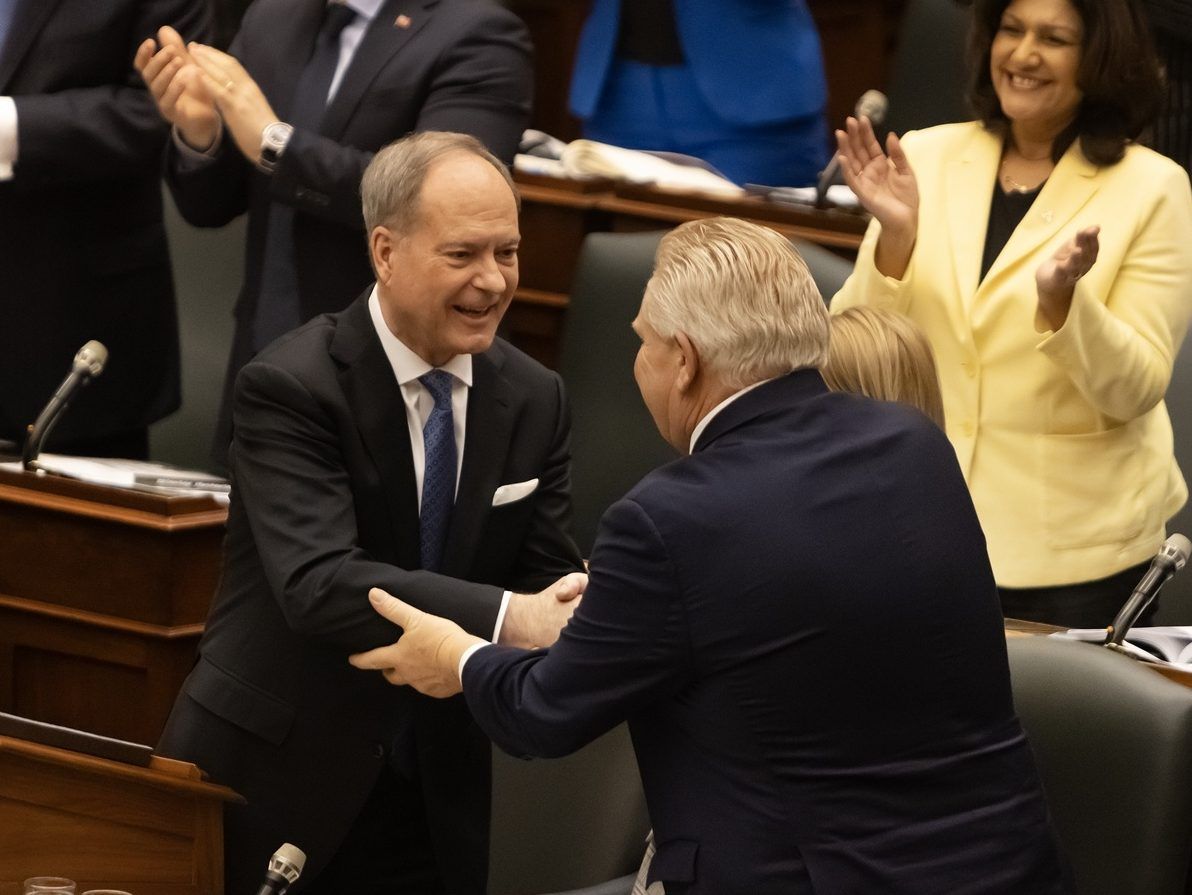 Ontario Premier Doug Ford, right, and Finance Minister Peter Bethenfalvy shake hands during the announcement of the 2026 budget at Queen's Park in Toronto on Thursday, March 26, 2026.