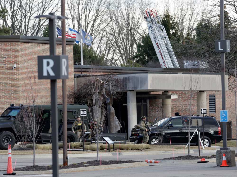 Law enforcement remain on site at the Temple Israel synagogue in West Bloomfield, Michigan, a Detroit suburb, on March 12, 2026, after an assailant drove a vehicle into the building. 
