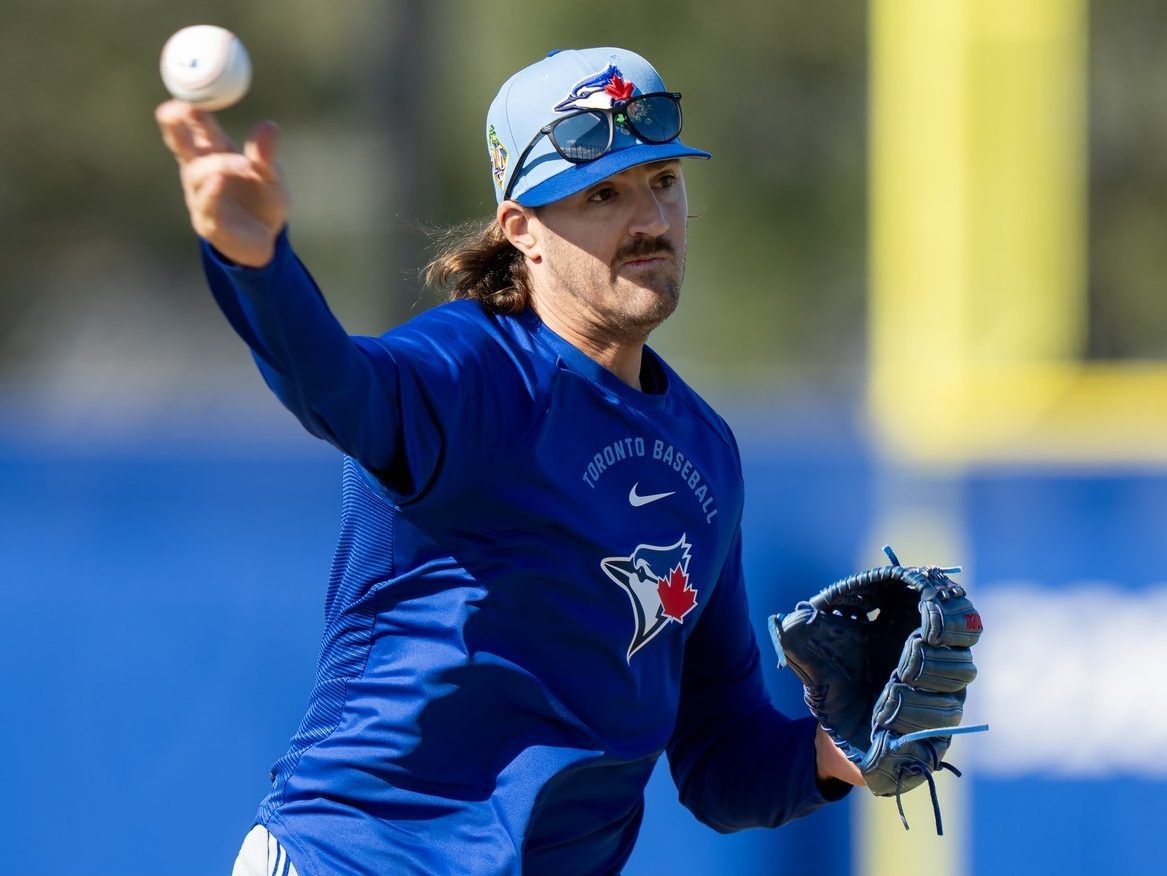 Toronto Blue Jays pitcher Kevin Gausman makes a throw to first base during a drill at Spring Training in Dunedin, Fla., on Monday, Feb. 16, 2026.