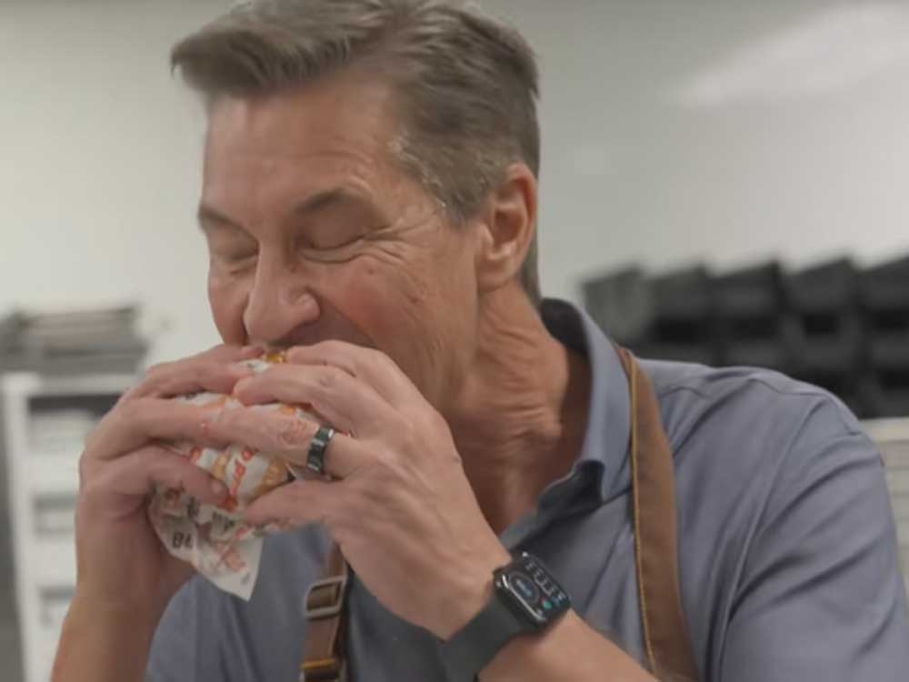  Burger King president Tom Curtis is seen in a TikTok video eating a Whopper.
