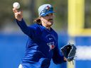 Kevin Gausman, making a throw to first base during a drill at spring training in Dunedin, will make his first opening-day start as a Blue Jays on March 27.
