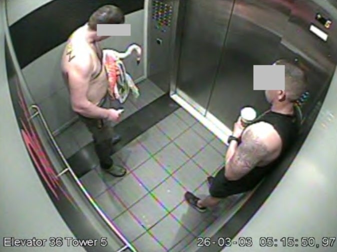  Surveillance footage that police say shows Michael Fairbarn in an elevator, with another man, returning to a hotel room with a flamingo stolen from the hotel’s bird habitat. (Las Vegas Metropolitan Police Department)