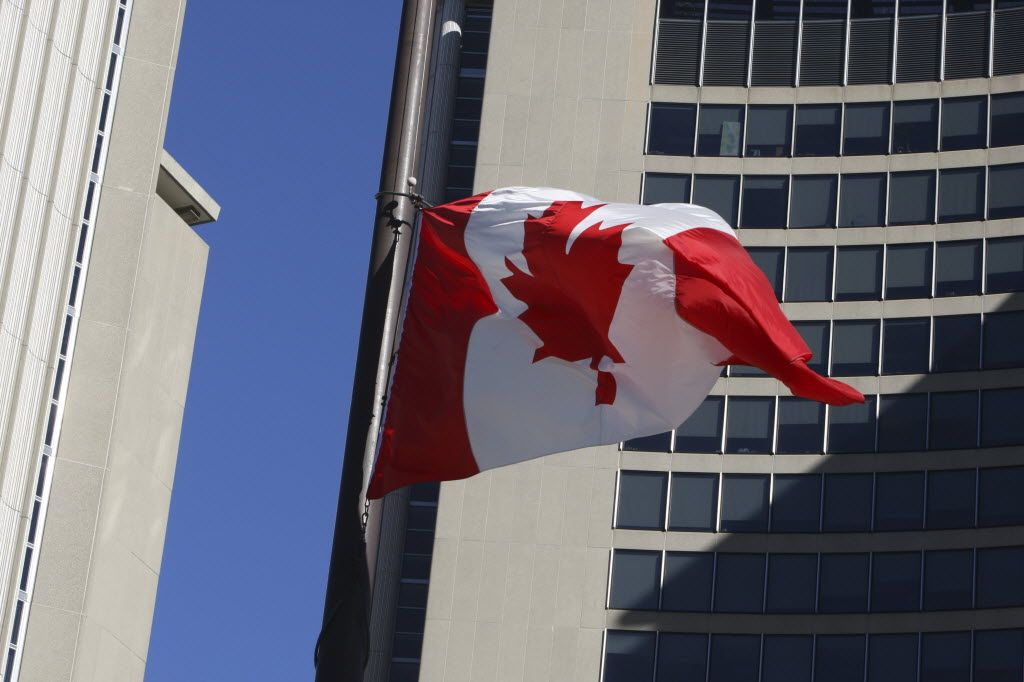 The Canadian flag flies outside of Toronto City Hall in October 2014.